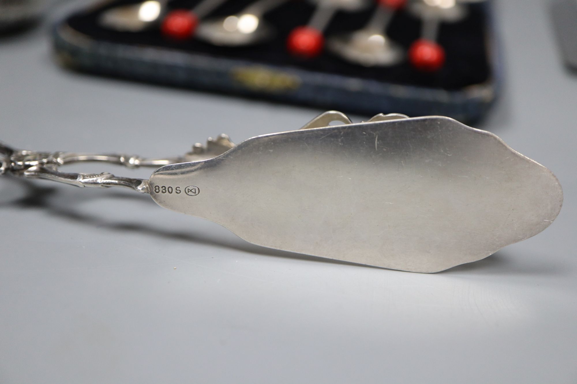 An 830s pastry tongs, a knife, a cased set of six bean end coffee spoons and an infuser.